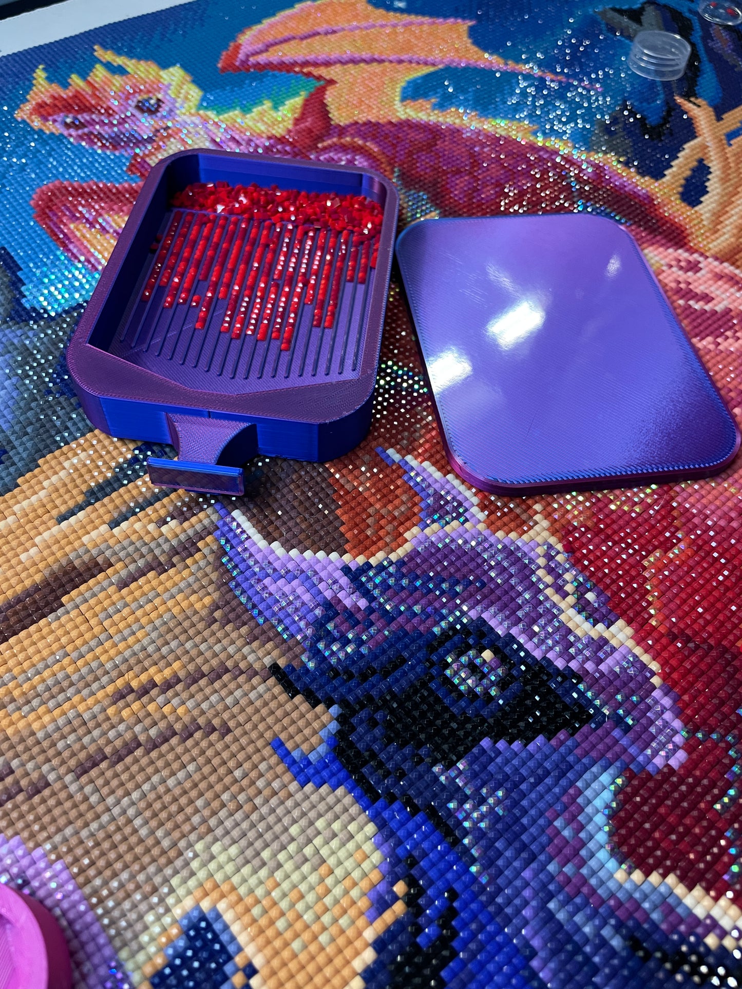 Purple Deluxe 2 Phoenix medium diamond painting tray on colorful canvas with red diamond drills