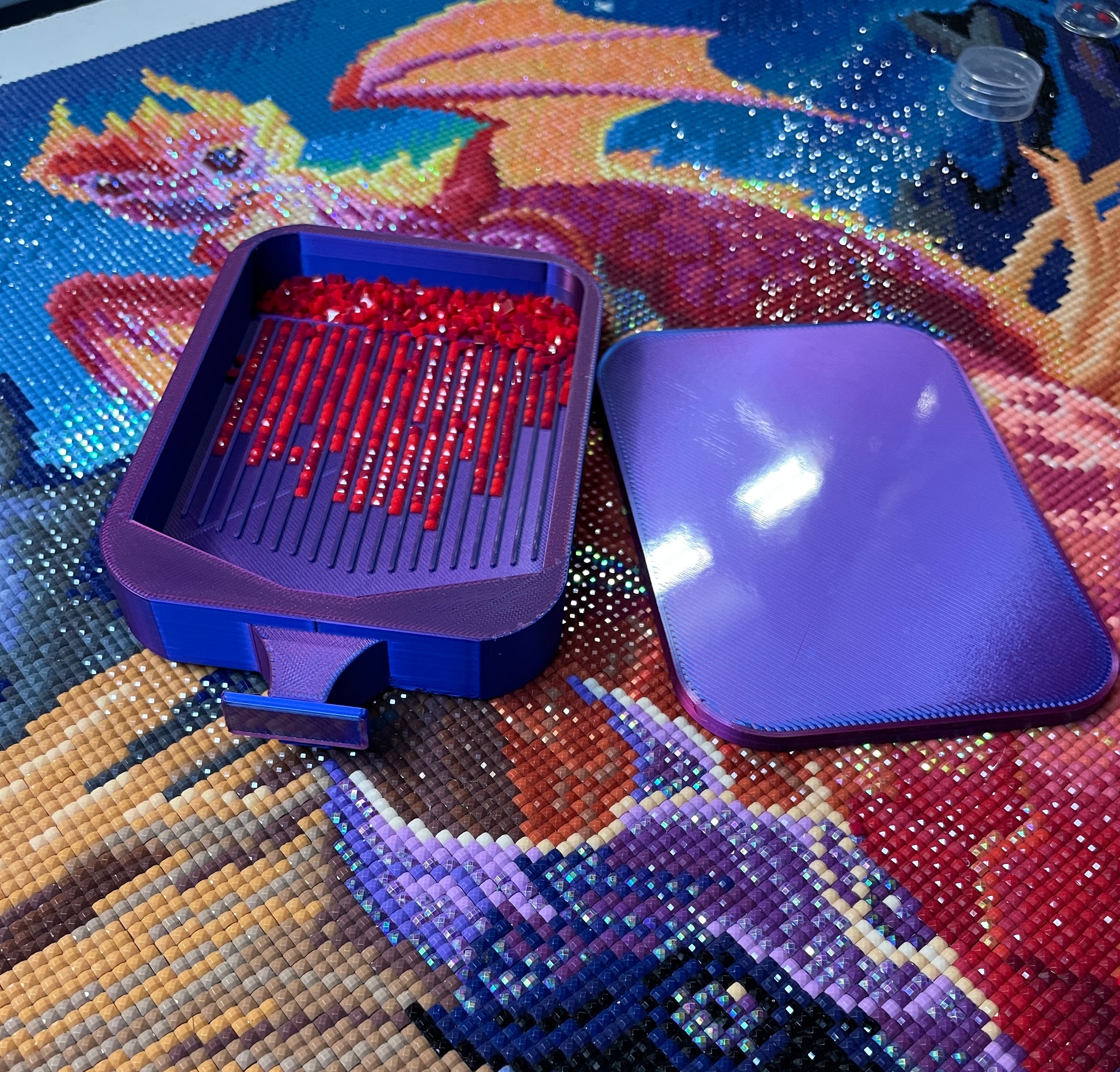 Purple Deluxe 2 Phoenix Medium Diamond Painting Tray on vibrant canvas with red diamond drills.