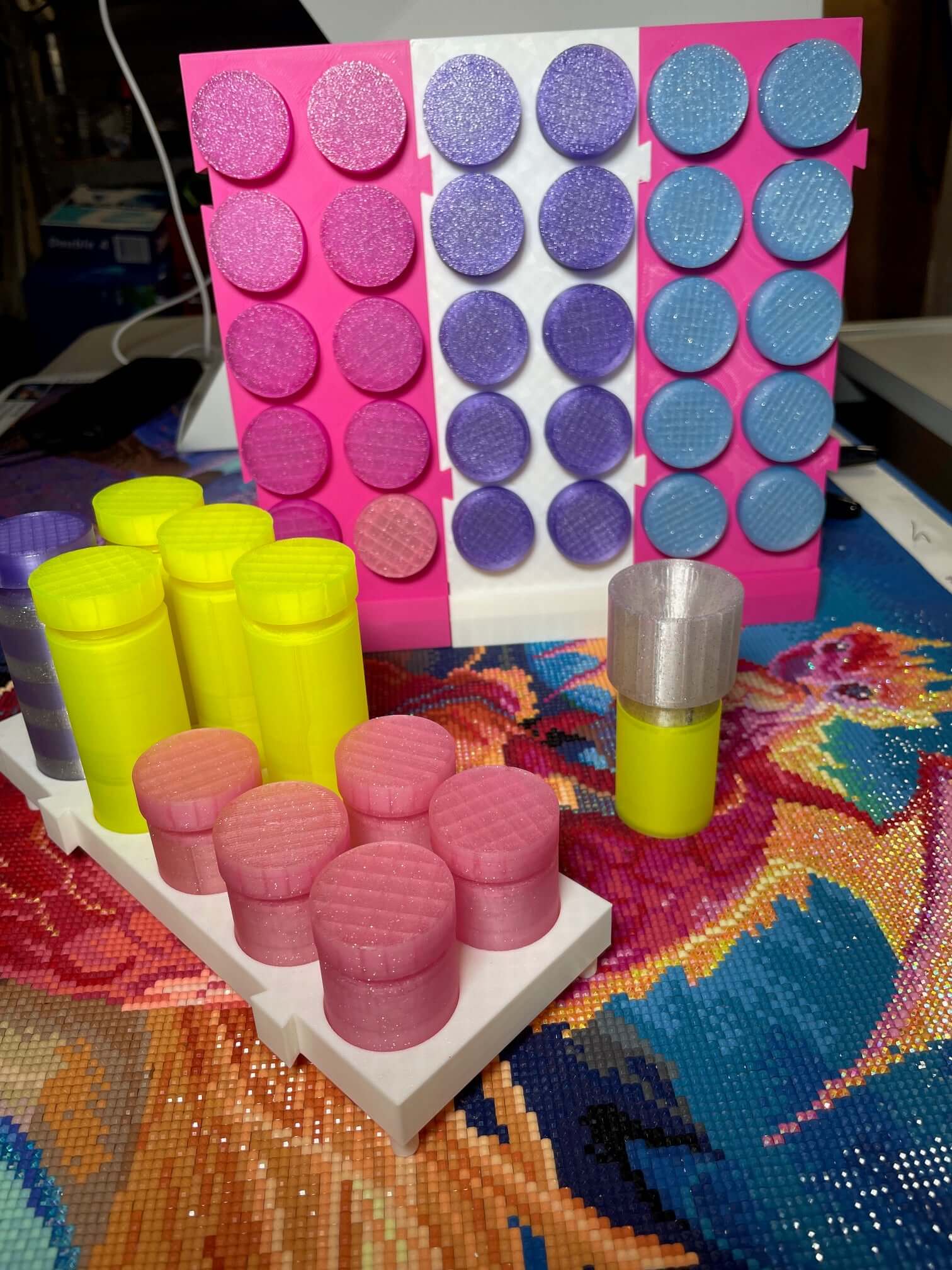 Colorful TestToobz Drill Containers with upright stand displayed on a craft table.