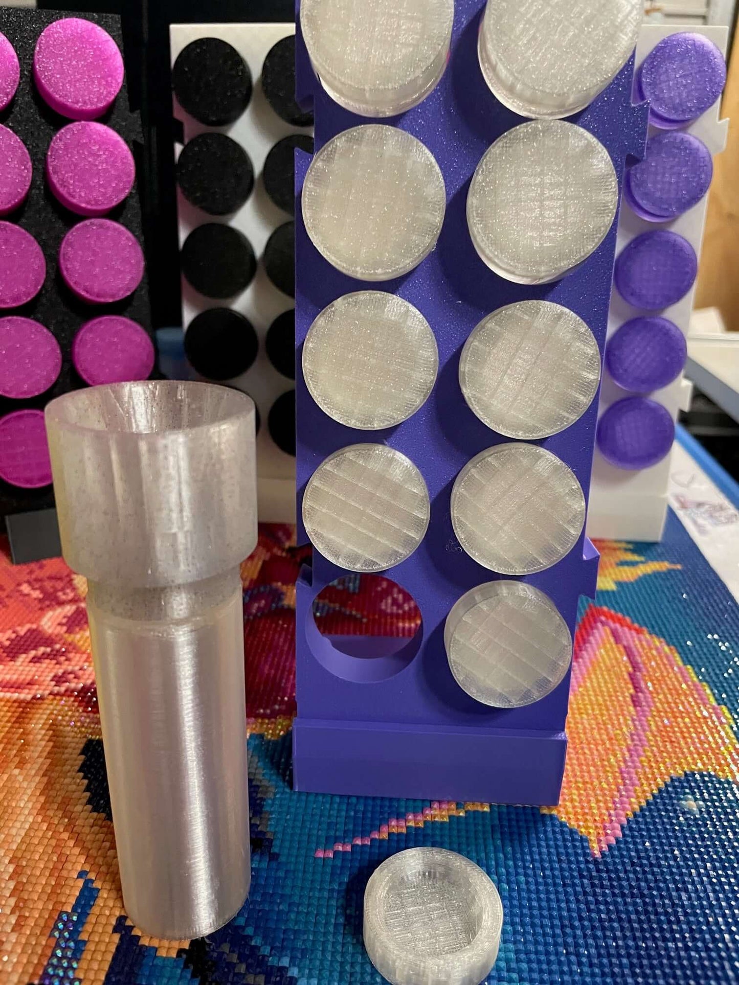 "TestToobz drill containers on expandable stand with screw-on funnel, displayed in crafting setup."