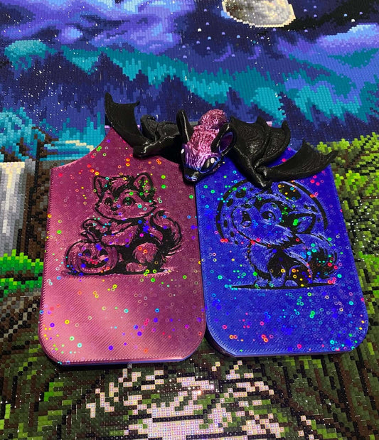 Halloween dragon trays with werewolf designs and a vampire bat buddy on a colorful diamond art background