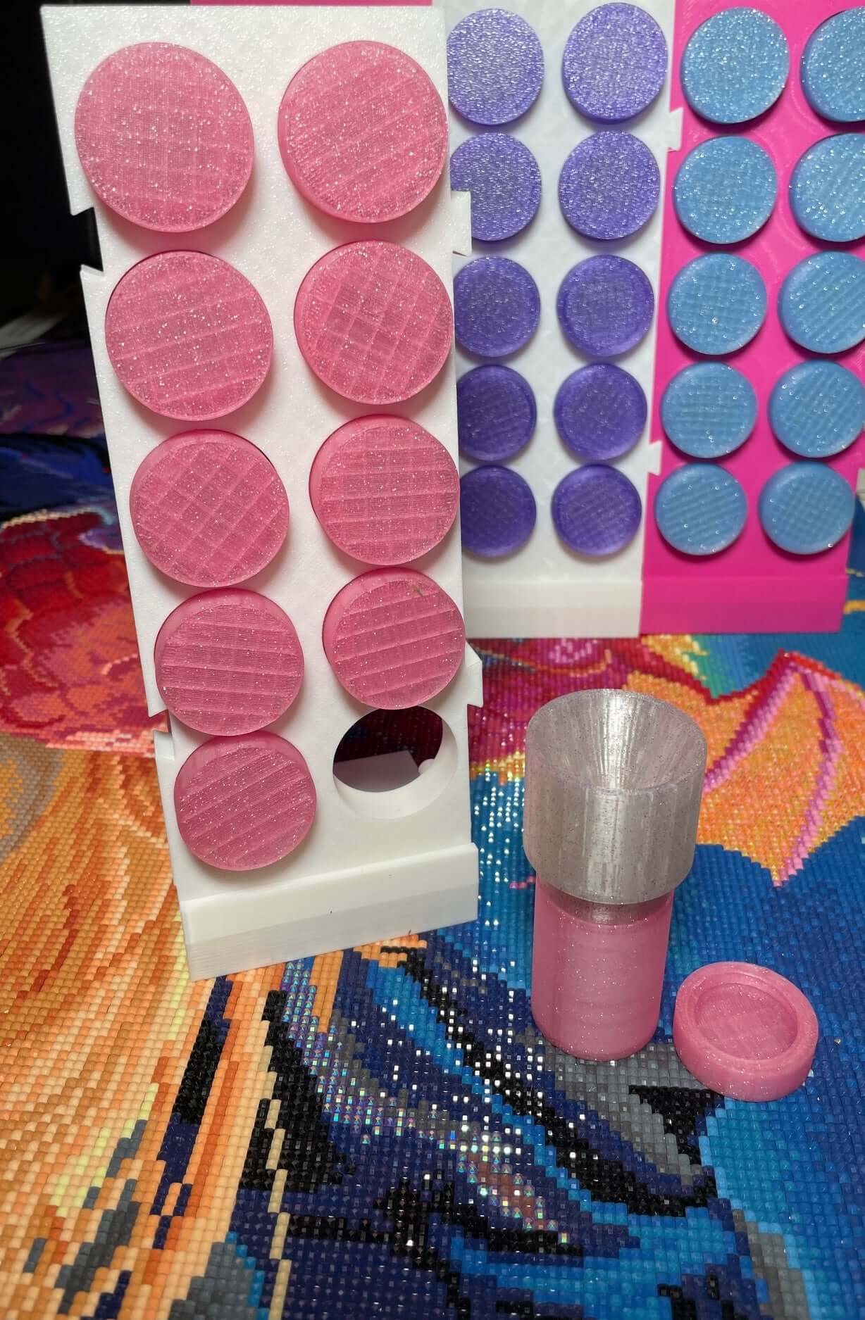 Pink drill containers with expandable stand and screw-on funnel displayed on colorful craft background.